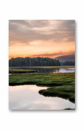 Sunset in Arcadia, Maine USA over a river and mountain landscape.
