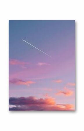 Tranquil sunset sky with soft clouds and airplane contrail — poetic gradient of purples, pinks and oranges in nature-meets-technology scene