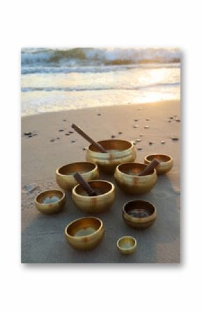 Tibetan Singing Bowls on Beach at sunrise.