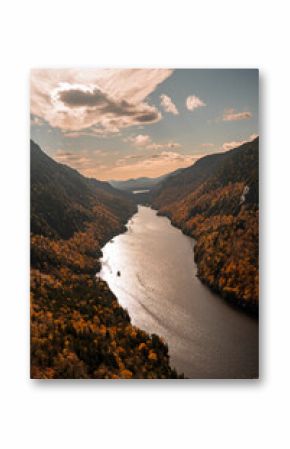 Up State New York in the Adirondack State Park during peak Fall Autumn season with golden maple leaves along the Hudson river. Trail up the Indian Head Lake view point.
