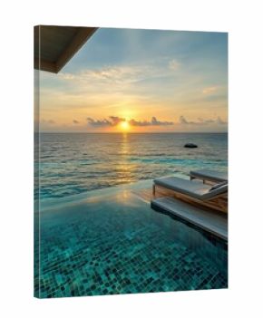 Luxurious Beachfront Villa With Infinity Pool at Sunset Overlooking Calm Ocean Waters.