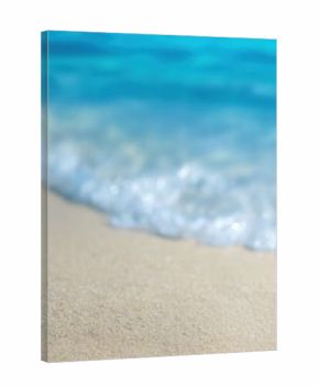 Close up of soft wave washing sandy beach with turquoise water in background, creating relaxing and idyllic summer vacation scene
