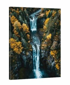Aerial top down view of stunning waterfall outdoors nature forest.