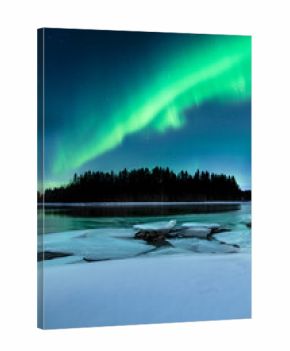 Northern lights over the Gäddviksundet in Luleå, Sweden. The water is open this winter night and on the shore lies white snow and ice floes
