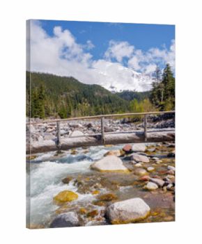 Majestic Mount Rainier rising above forests and river in the national park
