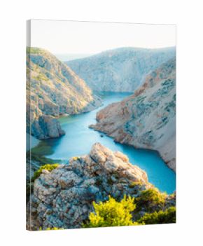 View of the Zrmanja River Canyon in Croatia, with winding turquoise waters cutting through limestone cliffs. A scenic natural wonder popular for kayaking and hiking