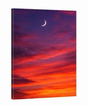 Vibrant sunset with crescent moon