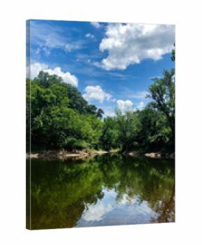 Tranquil Kinkaid Lake Spillway river scene with lush trees, blue sky, and reflections in Southern Illinois, USA