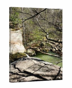 A rocky overlook above a green river in Southern Illinois forested canyon trail. Shawnee National Forest.