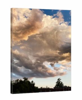 Dramatic sunset clouds over rural Southern Illinois skyline with trees and fence