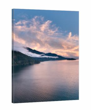 Sunset Over Coastal Mountains in British Columbia, Canada, Calm Water and Mist at Dusk