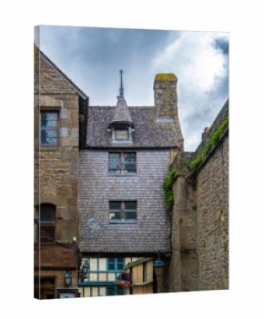 The Mont-Saint-Michel Abbey is an abbey located within the city and island of Mont-Saint-Michel in Normandy, in the department of Manche. The abbey is an essential part of the structural composition o