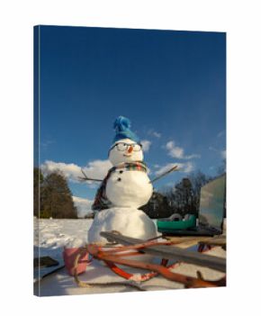 Snowman for winter greeting card. Snow man with winter background. Snowman with scarf and mittens in snow. Snowman outdoors winter fun. Snowman festive New Year outdoor.