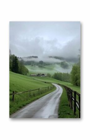 Scenic misty landscape with a winding road, green fields, and cozy farmhouses nestled in the hills.