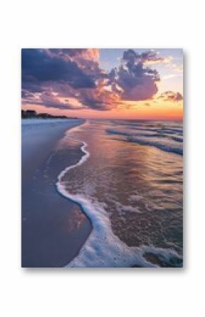 A breathtaking sunset over the Gulf Coast with gentle waves and colorful clouds reflecting on the shoreline