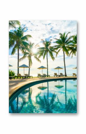 Beautiful luxury umbrella and chair around outdoor swimming pool in hotel and resort with coconut palm tree on blue sky