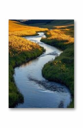 Picturesque countryside river winding through vibrant rolling hills and lush green meadows