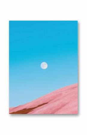 A large moon is in the sky above a pink hill. The sky is clear and blue, and the moon is the only object in the scene