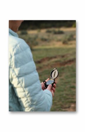 Woman with a compass in her hands in a clearing