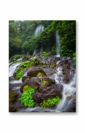 Lush Tropical Waterfall Flowing Through Green Jungle Landscape in Indonesia