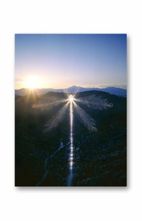 Aerial View of Dragonfly Shaped Light Pattern over Desert Mountains at Sunset