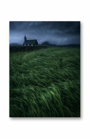 Grassy Icelandic field with a church in the background