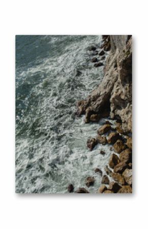 Rocks on the beach with blue sea in Italy. Summer concept. Natural background