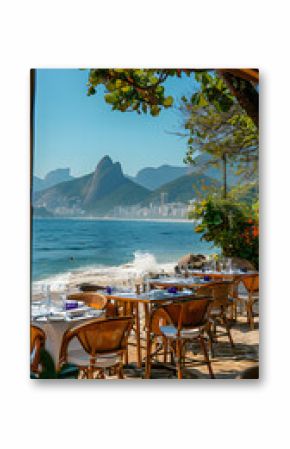 Restaurant with tables and chairs on beach, overlooking azure ocean