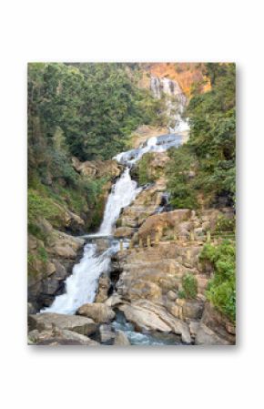 A waterfall is flowing down a rocky hillside