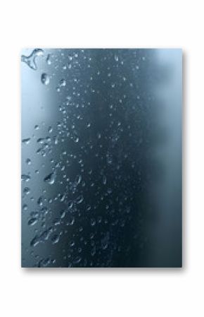 rain drops on a window with a sky in the background