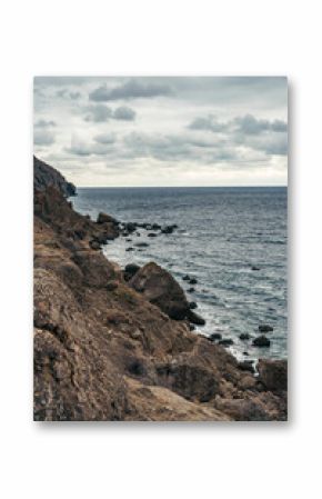Rugged coastal landscape with rocky shoreline and moody sky near the ocean