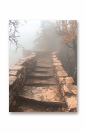 Stone Steps Leading Upward Through Foggy Mountain Landscape