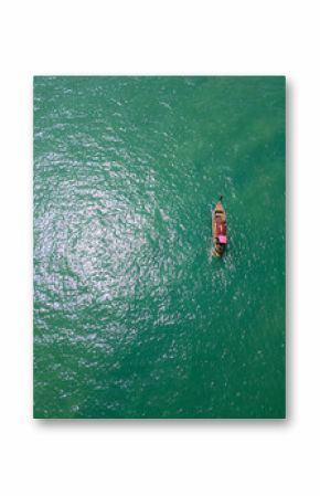 Aerial view of a sailboat cruising along Thailand exotic coastline, breathtaking scene of a motorboat navigating the turquoise waters. Passing by scenic coastal cliffs and a tropical shoreline.