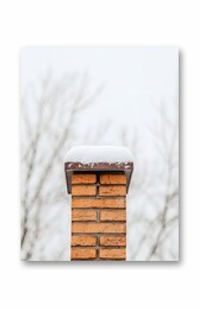 Snow Covered Brick Chimney on Rooftop in Winter