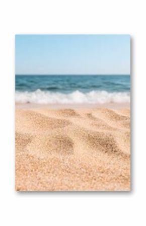 Close Up View of Light Brown Sand Beach with Ocean Waves and Blue Sky