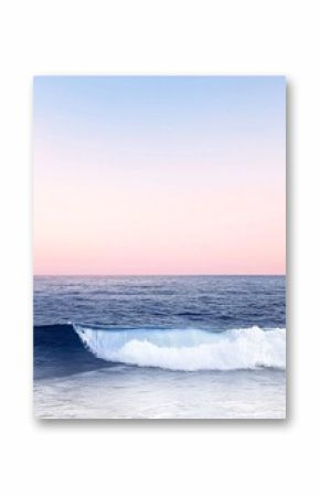 Soft Pink Sunset Over a Calm Ocean with a Gently Rolling Wave