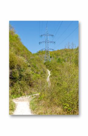 A power line tower is seen in the distance