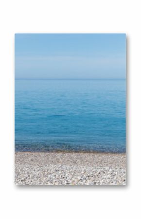 A calm ocean with a rocky shoreline