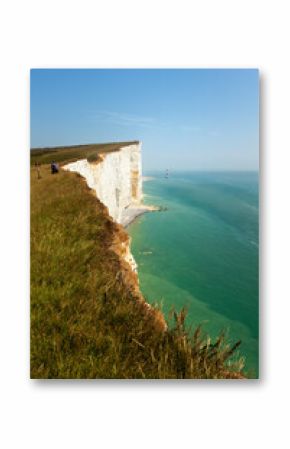 Tourists on the edge of Beachy Head cliff on the English Channel coast, East Sussex, UK