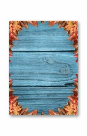 Wooden plank surface is featuring rustic flat design with autumn leaf border in muted blue