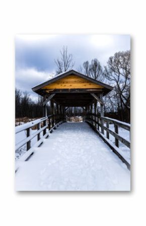 wooden covered bridge in the snow