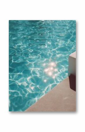 Sunny reflection on crystal clear water by the poolside during a warm afternoon