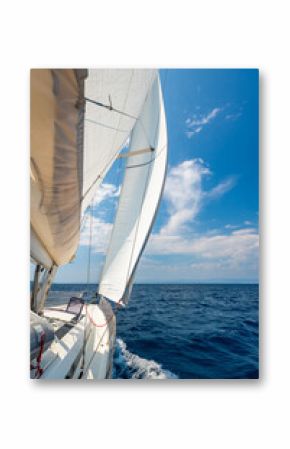 Side of a sailing yacht cutting through the sea with full sails near Croatia. Motion, freedom, sailing lifestyle and adventure on the open water.