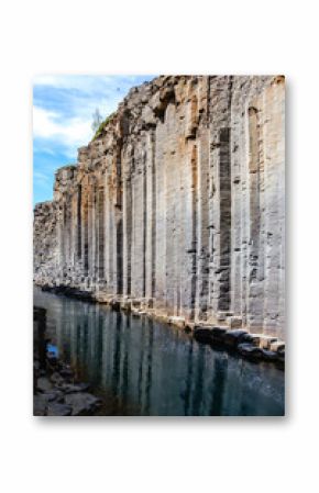Discover the stunning beauty of Studlagil Canyon in Iceland, where towering basalt columns rise from the crystal-clear river. Ideal for adventure seekers and nature lovers exploring the outdoors.