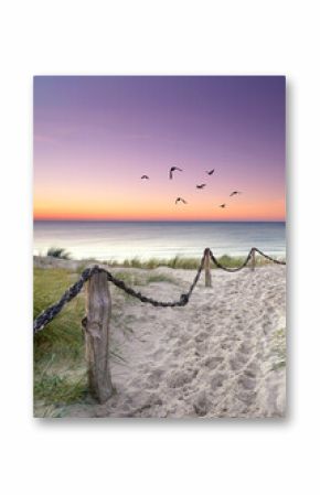 Sunset Stroll Along a Weathered Sandy Path Through Coastal Dunes