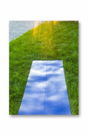 yoga mat in the grass at sunset