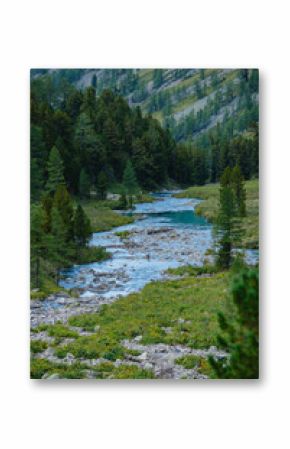Serene mountain landscape with river flowing through forest and rocky terrain