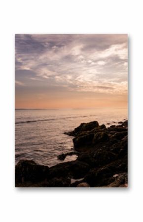 Bar Harbor, Maine Sunset in the Summer. Atlantic Ocean View with warm sky behind the lighthouse.