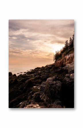 Bar Harbor, Maine Sunset in the Summer. Atlantic Ocean View with warm sky behind the lighthouse.