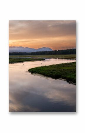 Sunset in Arcadia, Maine USA over a river and mountain landscape.